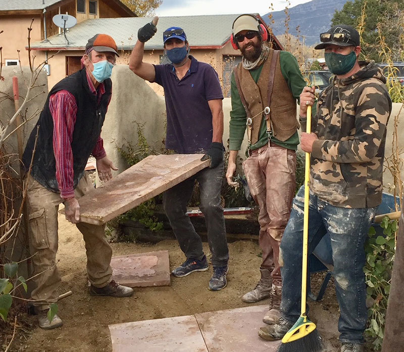 Andrew Hay's four friends creating a flagstone path in his yard