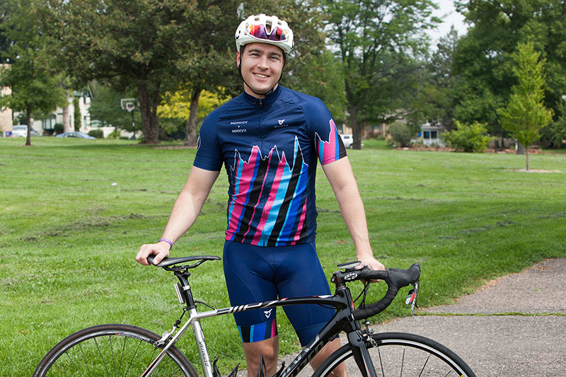 Craig Grad Mike Wolfner posing with bicycle wearing helmet