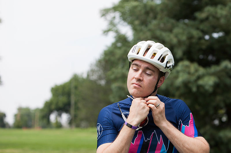 Craig Grad putting on helmet before biking
