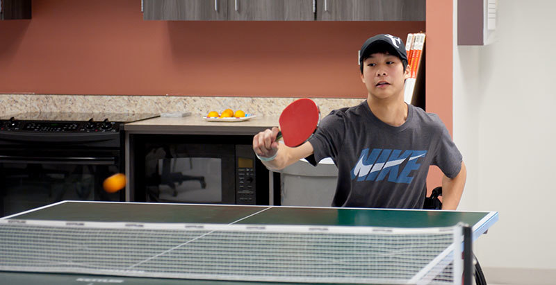 Jason Keatseangsilp playing table tennis at Craig Hospital