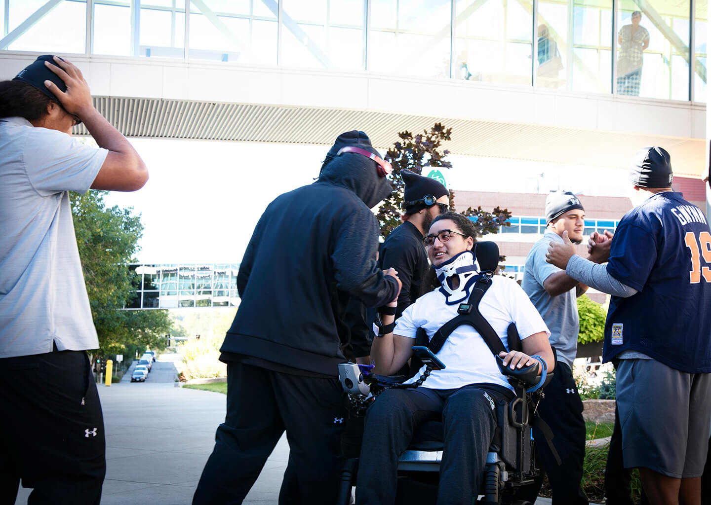 Kalepo Naotaia reconnecting with the University of Hawaii football team during his spinal cord injury rehabilitation at Craig Hospital.